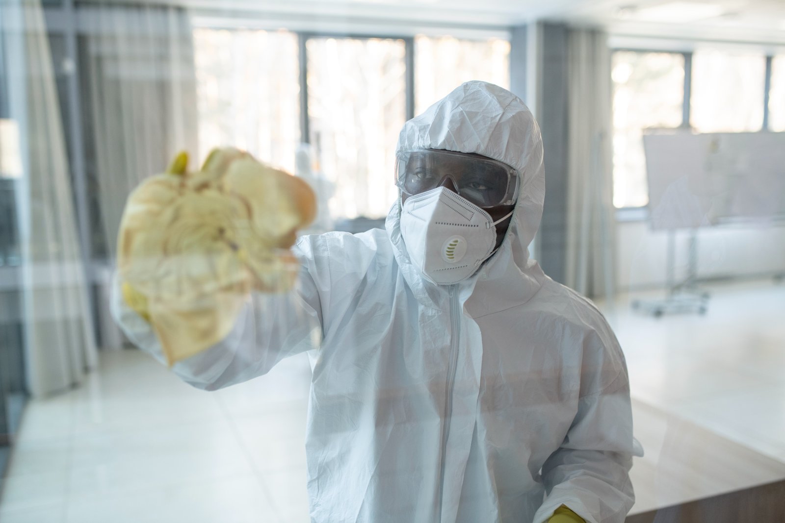 medium-shot-man-hazmat-suit-cleaning